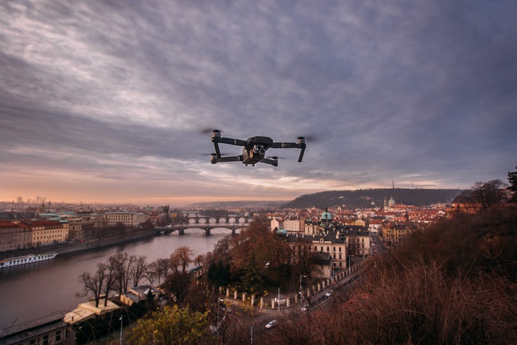A drone over a river. Learn how to fly yours with Drone Training